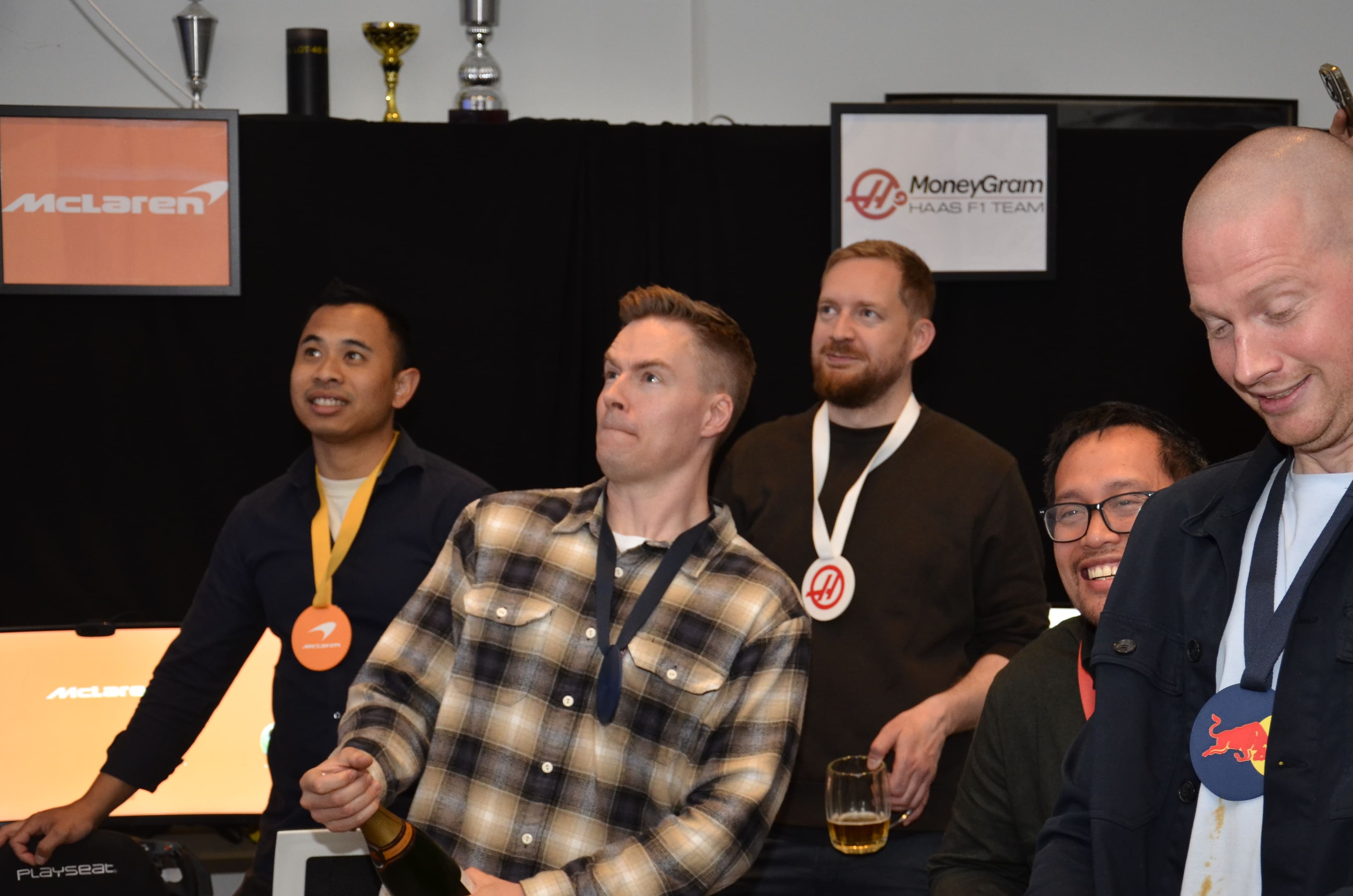 Winners celebrating with trophies and drinks